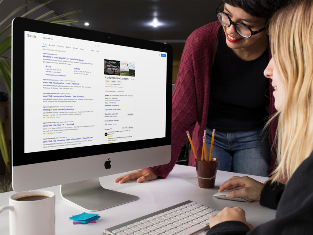 Pair of women using an iMac to Google Search